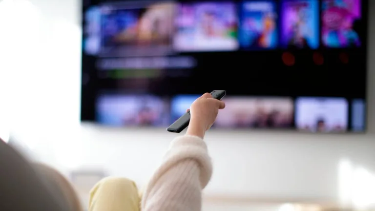 Family Watching TV At Home