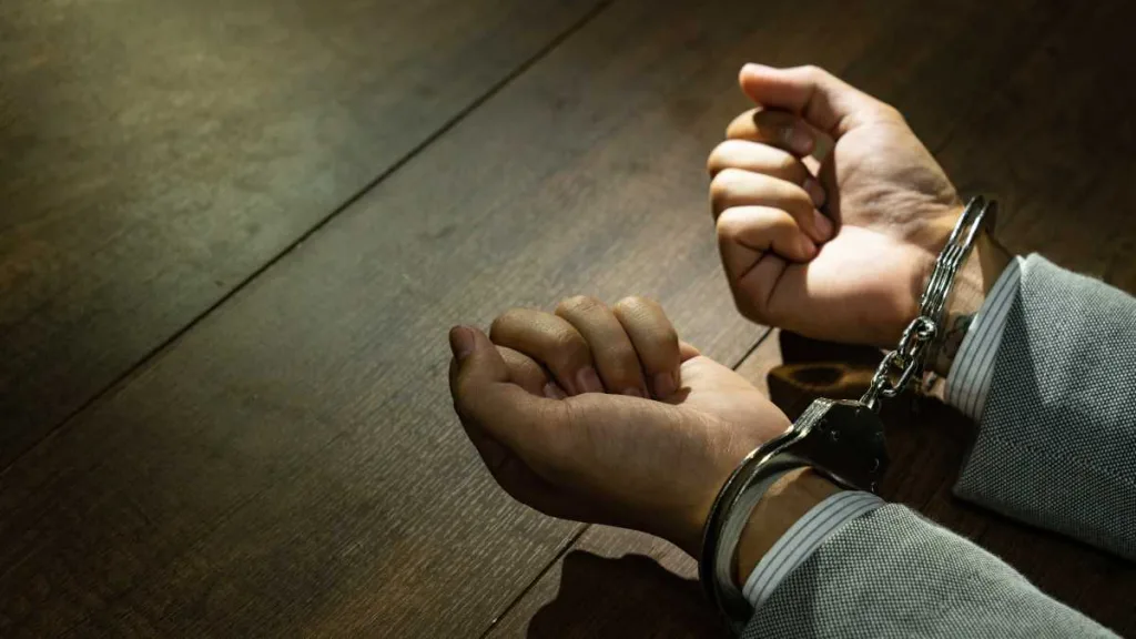 Male Hands In Handcuffs